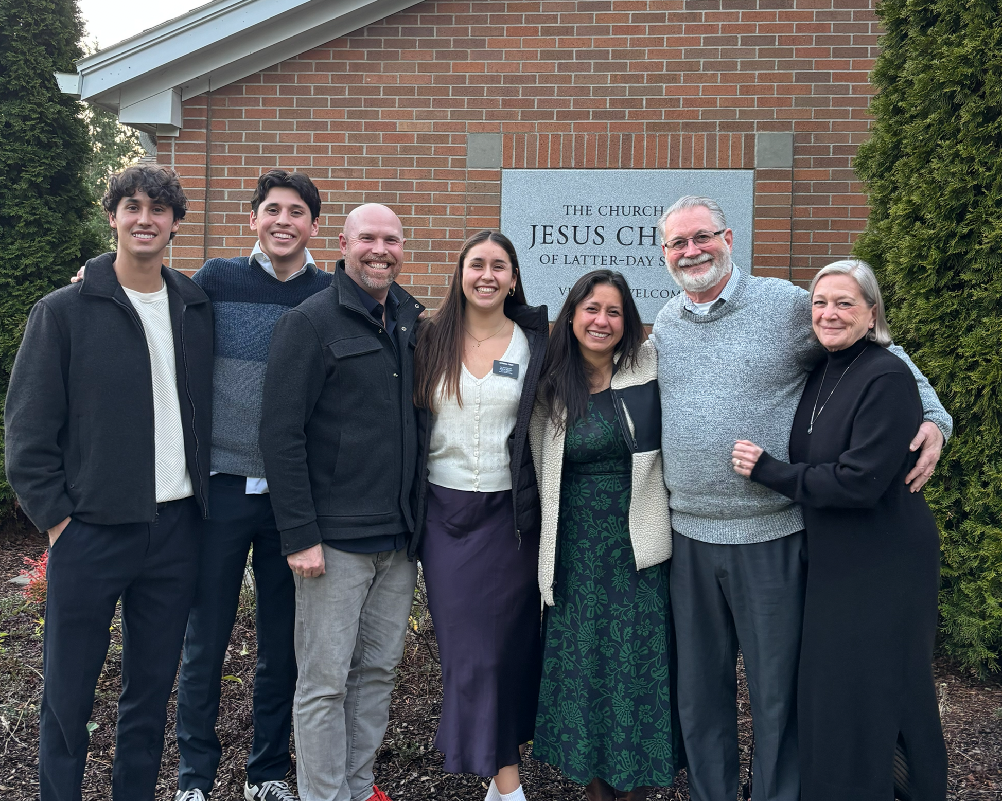 Michael Finch with his family and grand daughter before she goes on her mission. They are outside of an LDS Ward House.