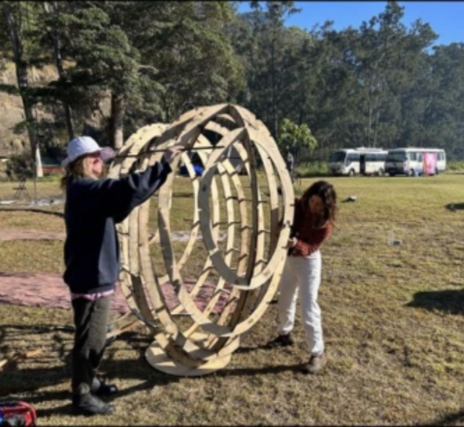 Large-scale whale installation assembled by people