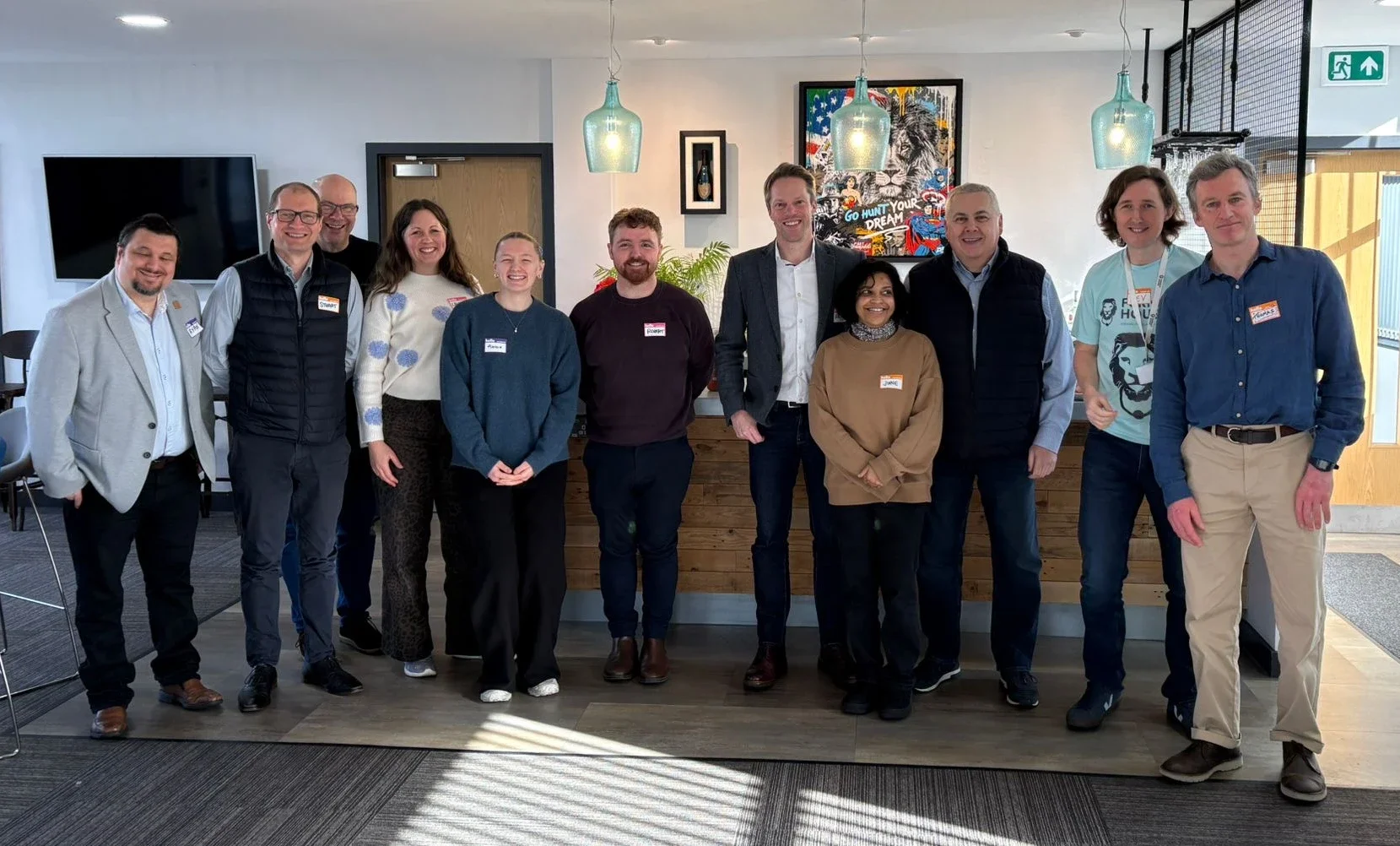 Laura Slack, Planet & Purpose standing smiling with other men and women in an office