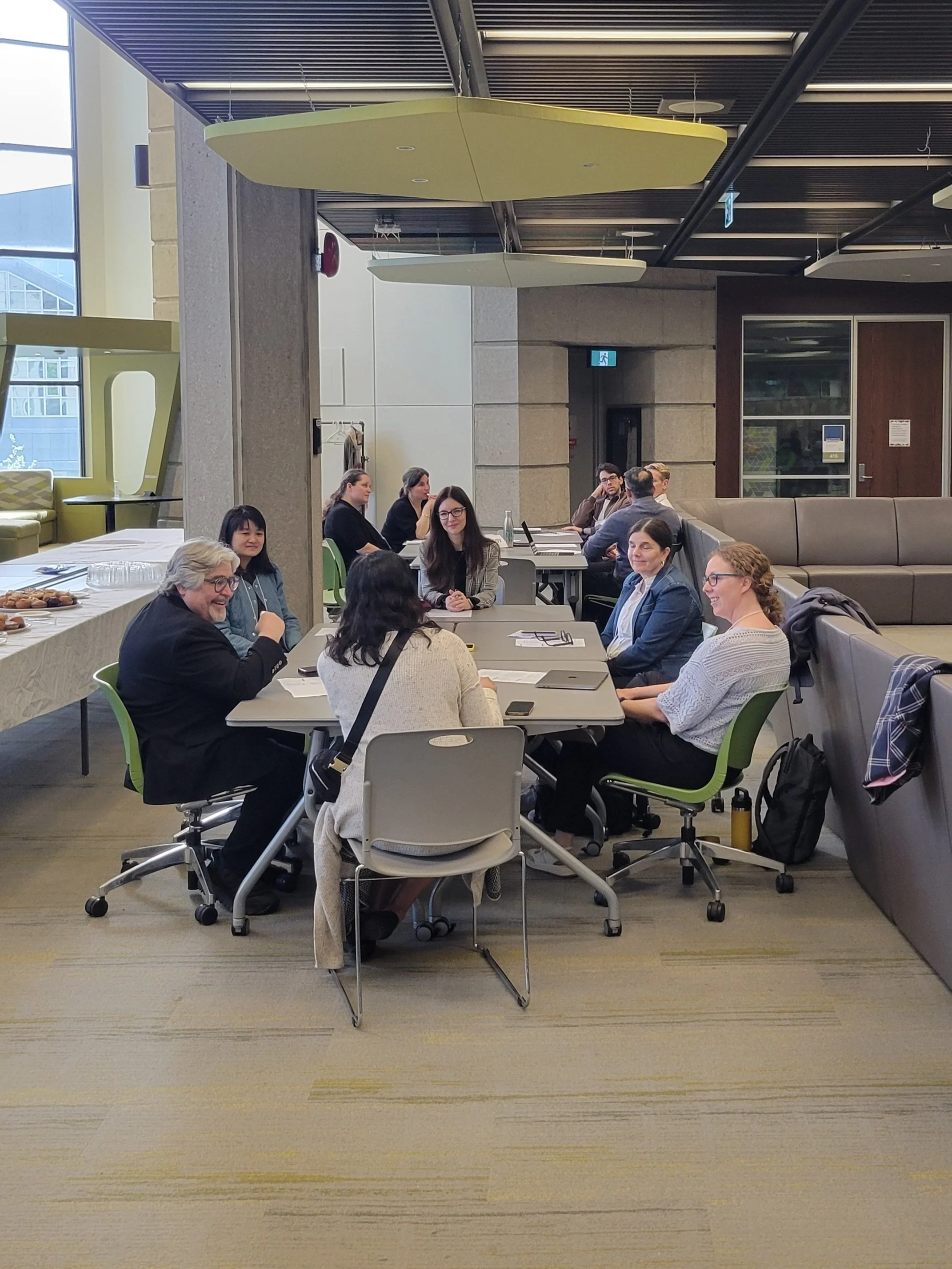 A small group of colleagues gathered around a conference table