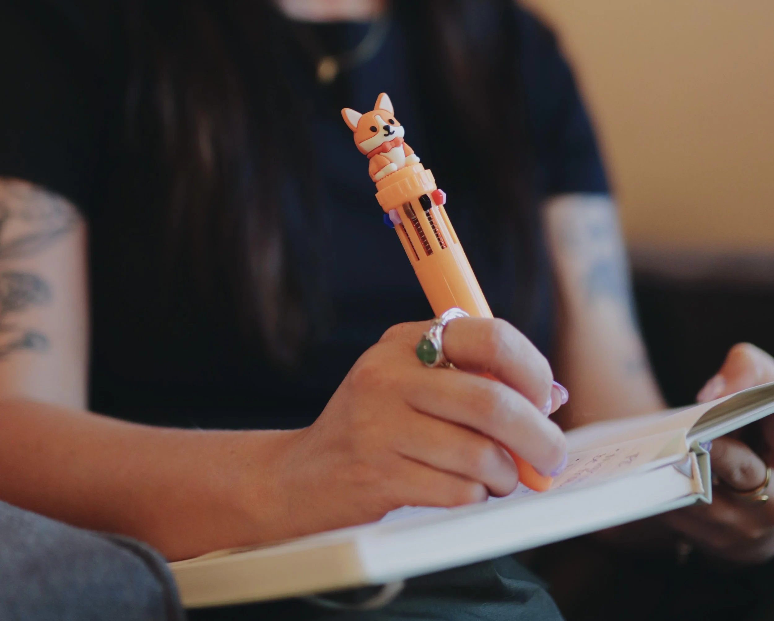 A therapist taking handwritten notes during a therapy session.