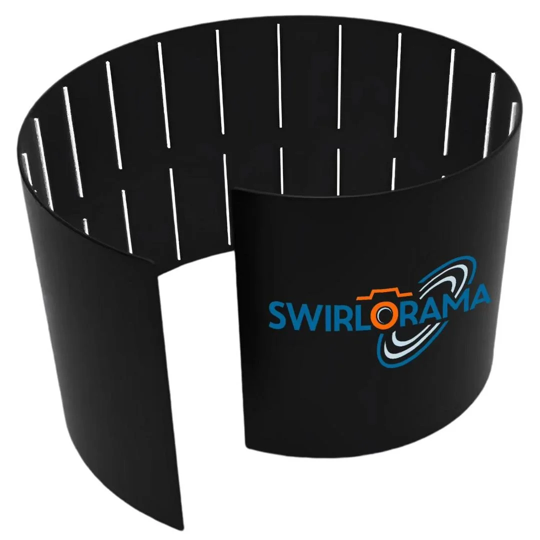 A black, semi-circular cylindrical object with slits inside and the SWIRLORAMA logo on the outside, featuring a camera icon and a swirl graphic.