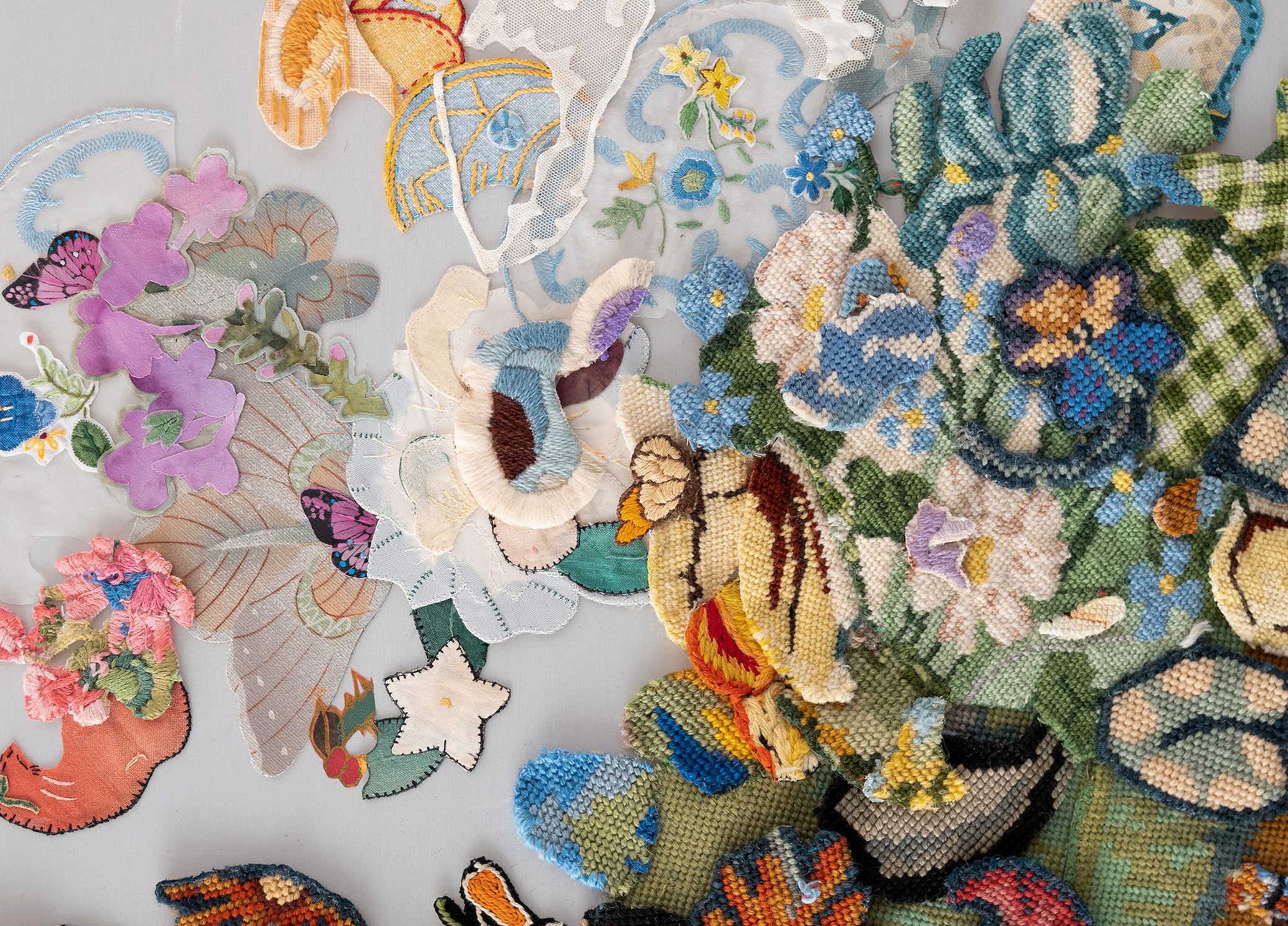 A collection of embroidered patches depicting natural-inspired designs on a gray background.