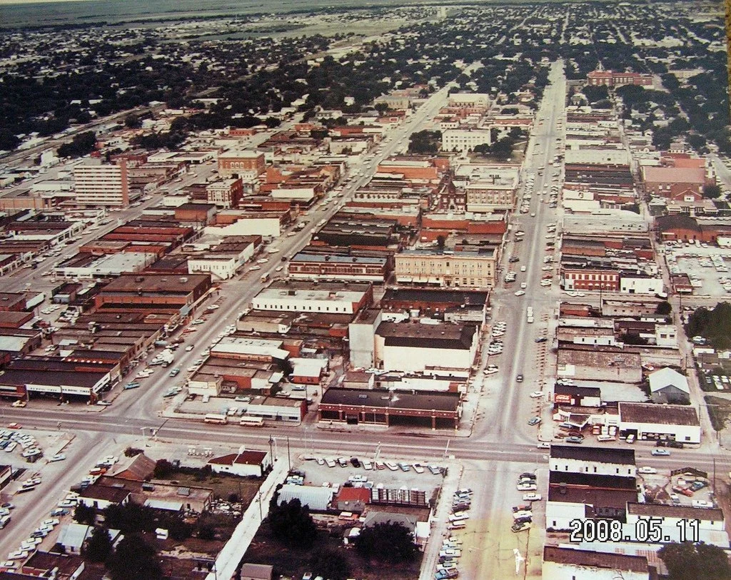 Aerial view of a Lawton, Oklahoma - downtown area with brick buildings, streets with cars, and a mix of commercial and residential areas, with a date of May 11, 2008, in the lower right corner.