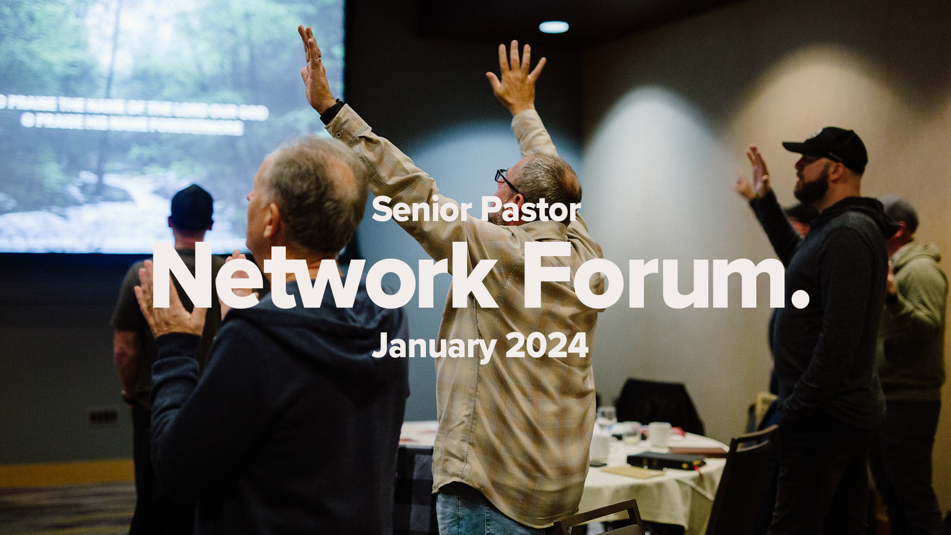 Three Men at Round Tables engage with Worship Music with hands lifted.
