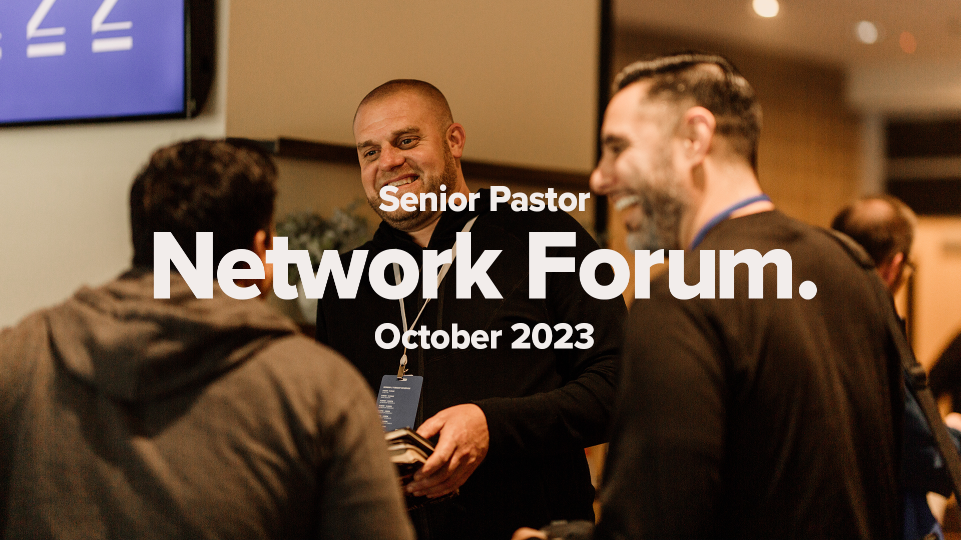 Three men great each other at an event. Senior Pastor Network Forum October 2023 Promotion