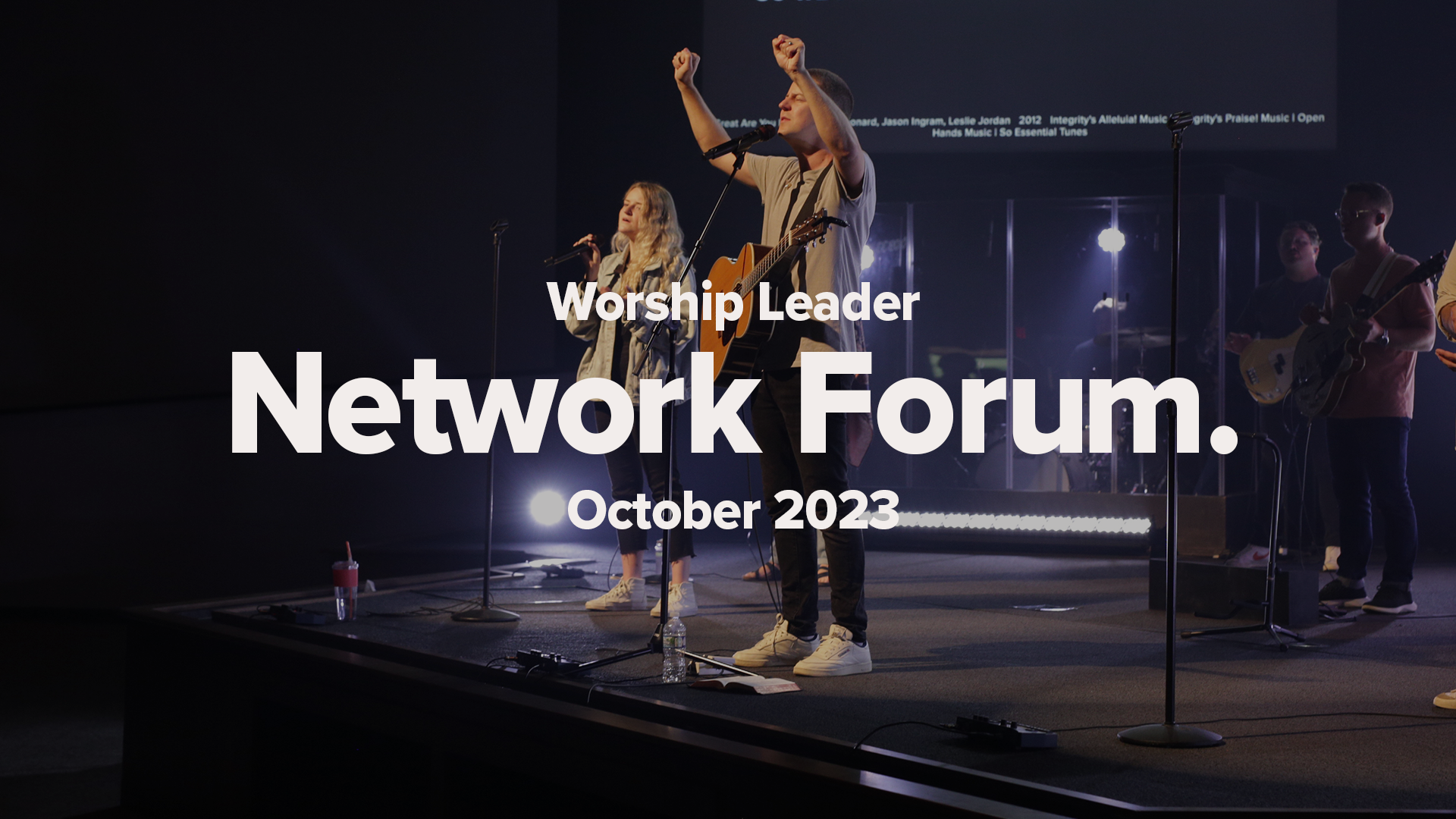 Worship leaders on stage in a dark church sanctuary. Worship Leader Network Forum October 2023 promotion.