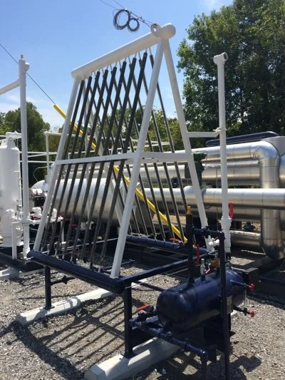 Industrial water treatment or filtration system with large metal and plastic components outdoors.