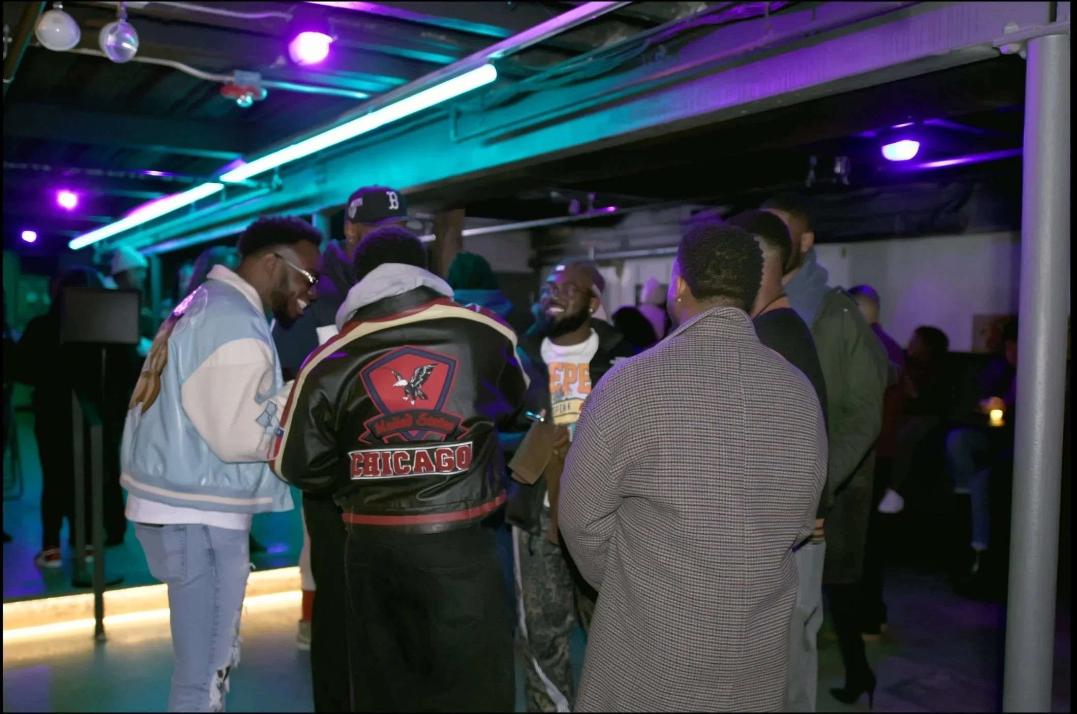 Group of men enjoy music on the dance floor. 