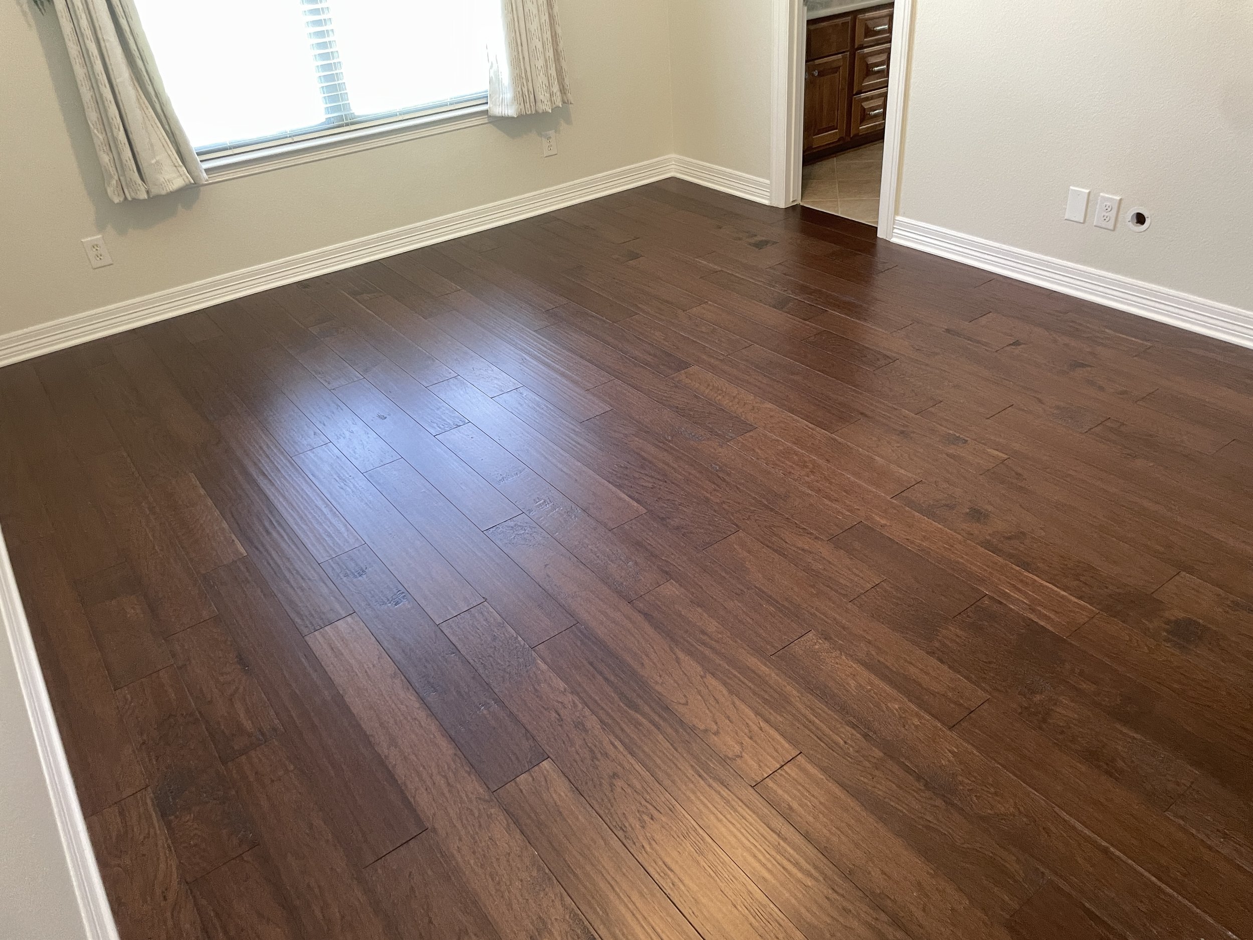 Engineered Wood Flooring Installation – San Antonio

Engineered wood flooring installation in a rich dark brown finish, adding depth and a more refined look to the space. Installed for a smooth, continuous flow across the room with clean transitions.