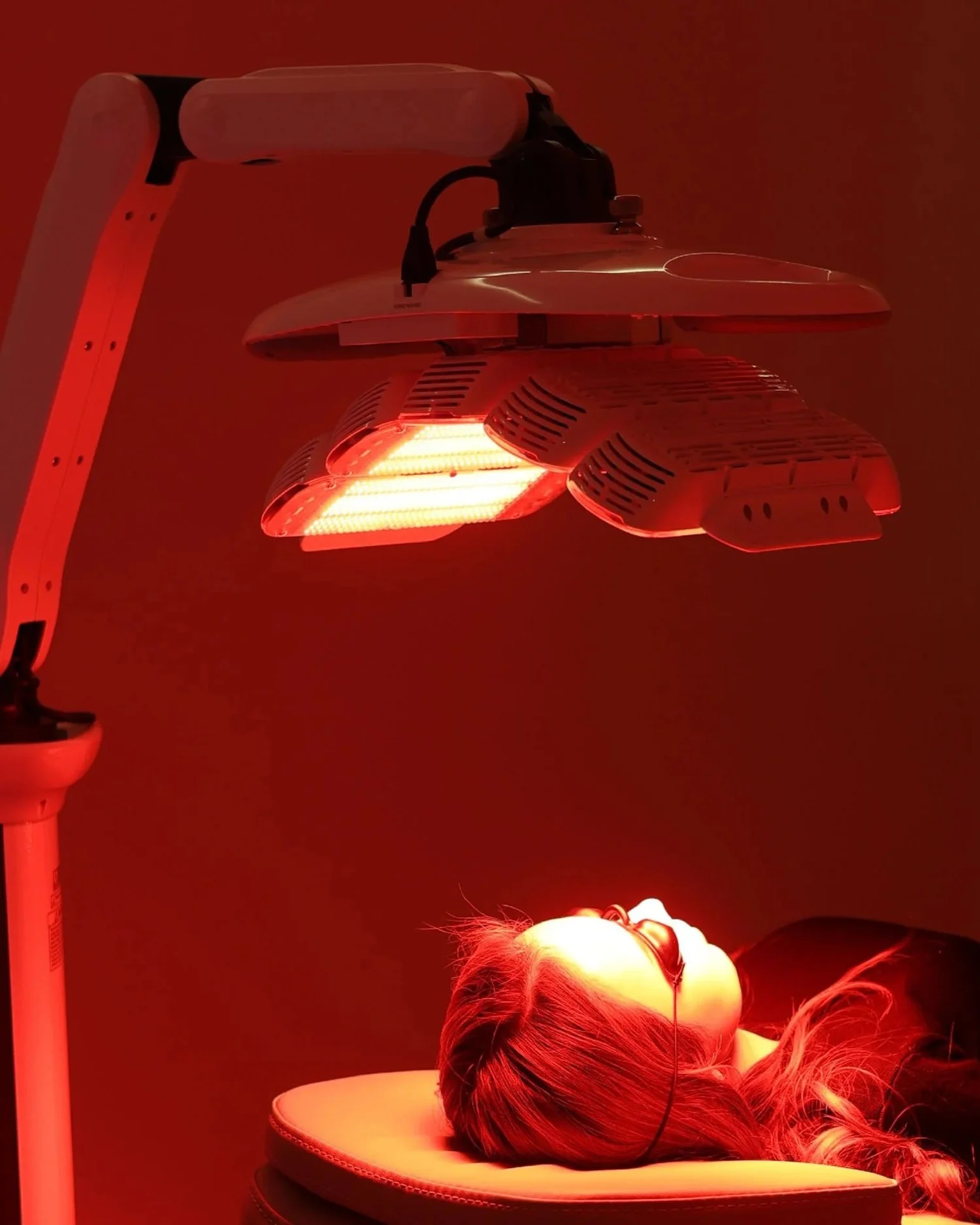 Red LED light panel over a patient's face, the light step of photodynamic therapy at DERM Skin Specialists, Mount Gravatt, Brisbane