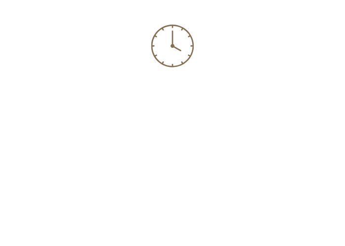 A wall clock showing 12:00 above a whiteboard or blank wall.