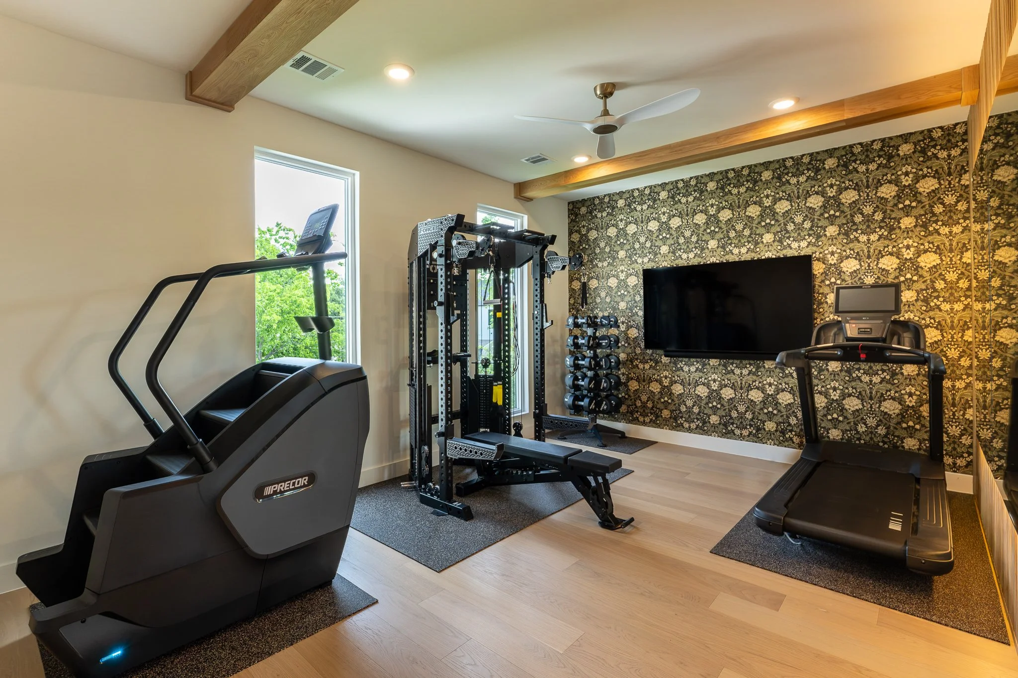 Close-up of matte black and brass faucet fixtures with marble countertop in high-end custom home gym refresh area