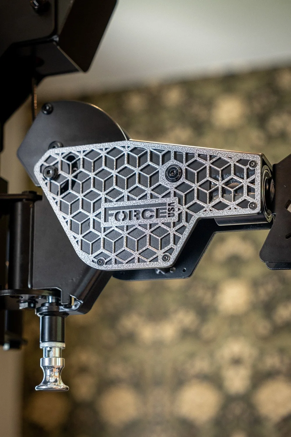 Close-up of Force USA strength equipment with textured metal detailing in custom home gym