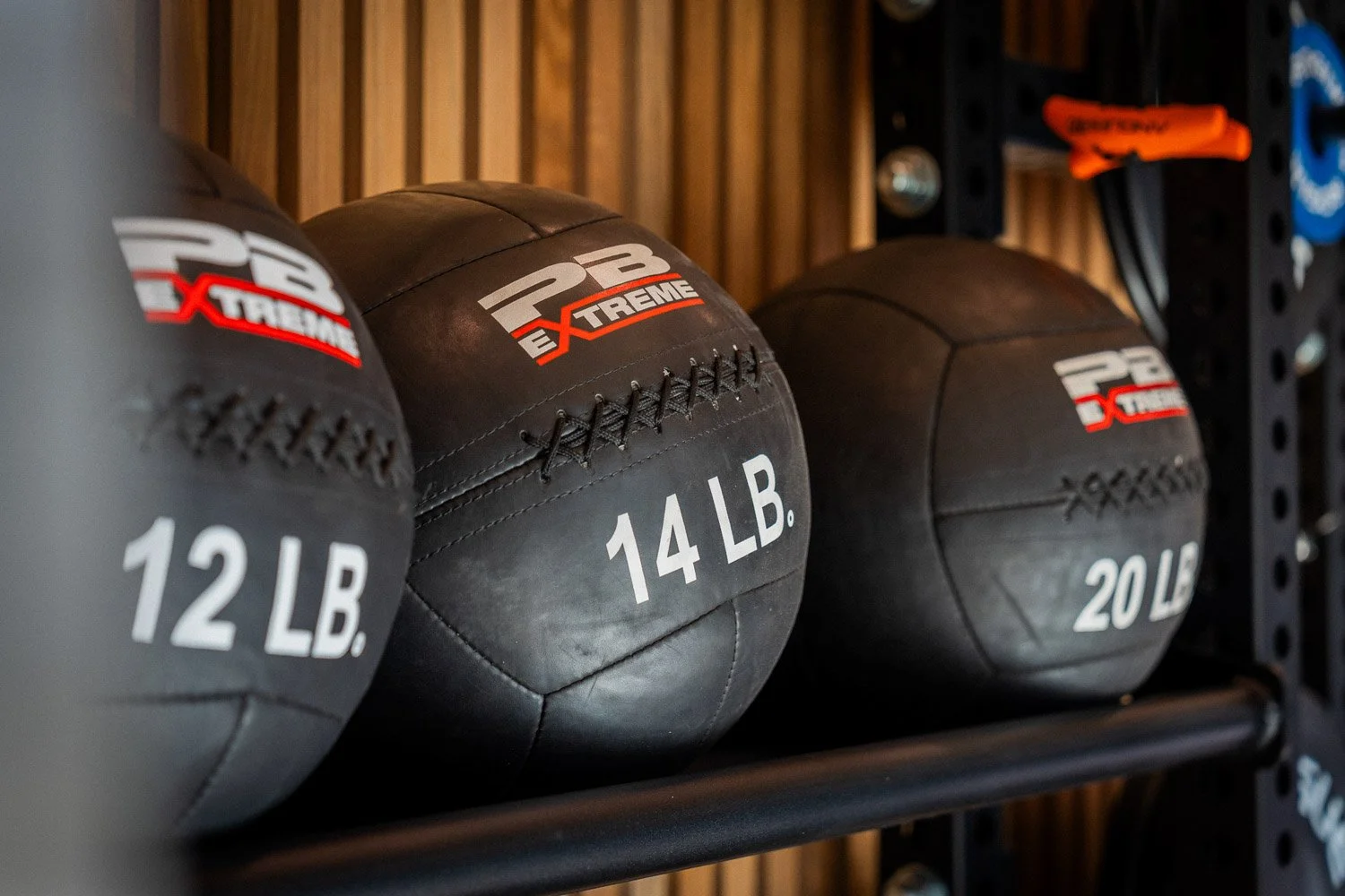 Close-up of weighted medicine balls on rack in luxury home gym with premium fitness equipment