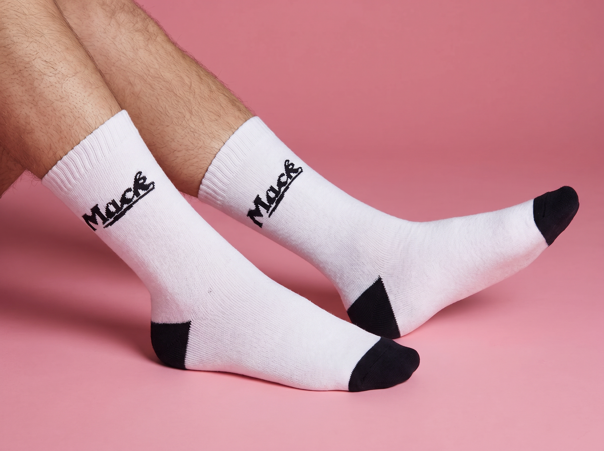 Person wearing white socks which says Mack