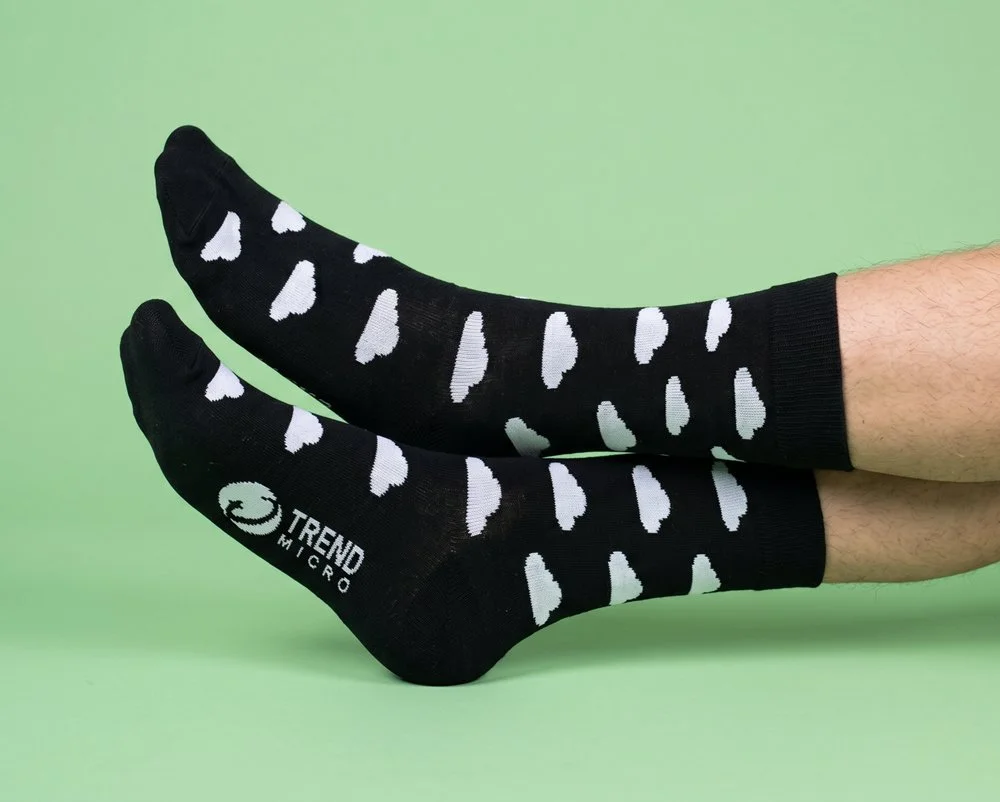 Black business socks with white clouds and Trend Micro logo on sole
