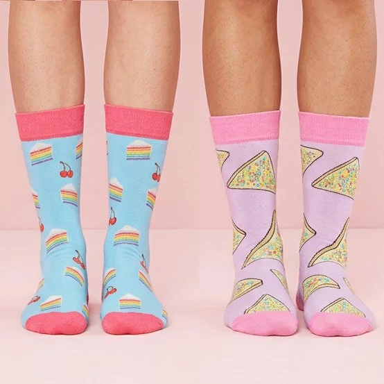 Two people wearing dress socks with digitally printed designs