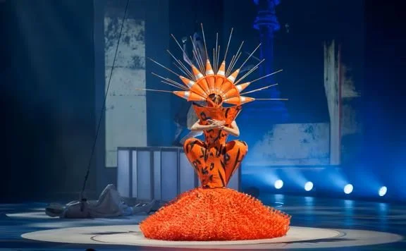 Woman wearing an orange dress for WOW