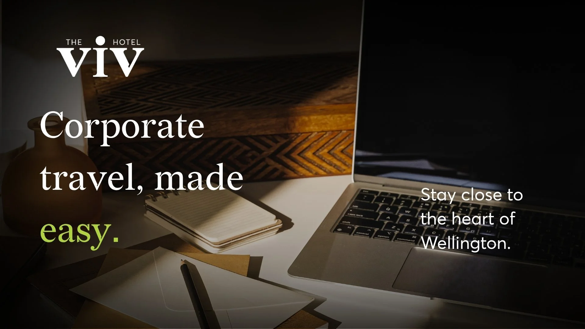 Laptop and notebook on a desk representing business travel and remote working at The Viv Hotel in Wellington CBD.