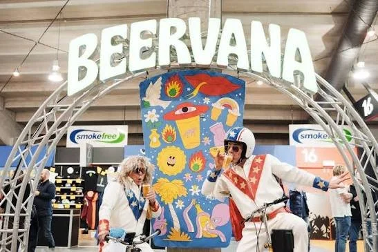 Festival-goers in themed costumes enjoying craft beer at Beervana in Wellington.