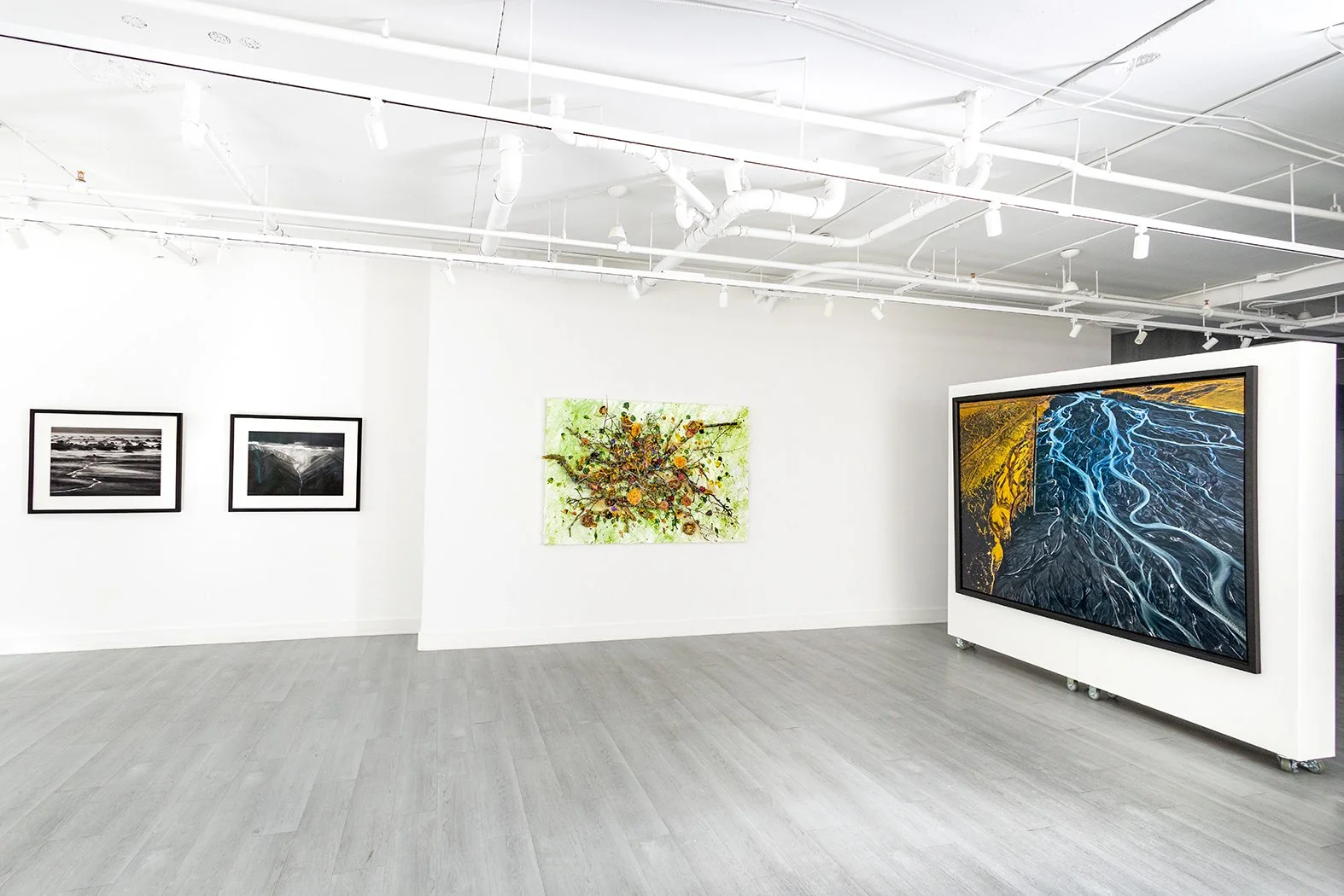 Art exhibition featuring work of Edward Burtynsky, Sebastião Salgado, and Susan Swartz