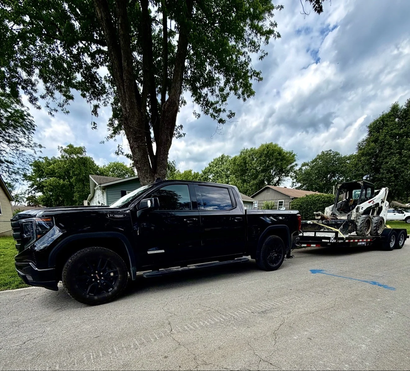 Crew truck and Bobcat on site