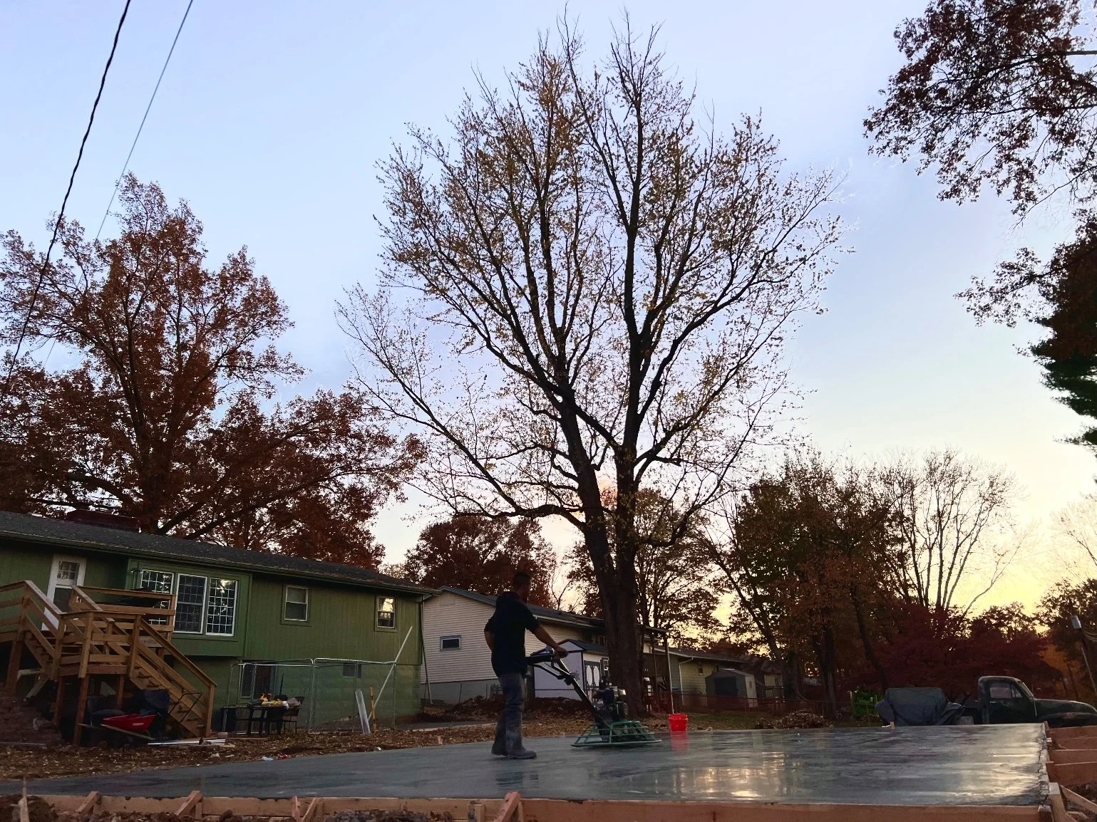 Pour — power trowel at dusk