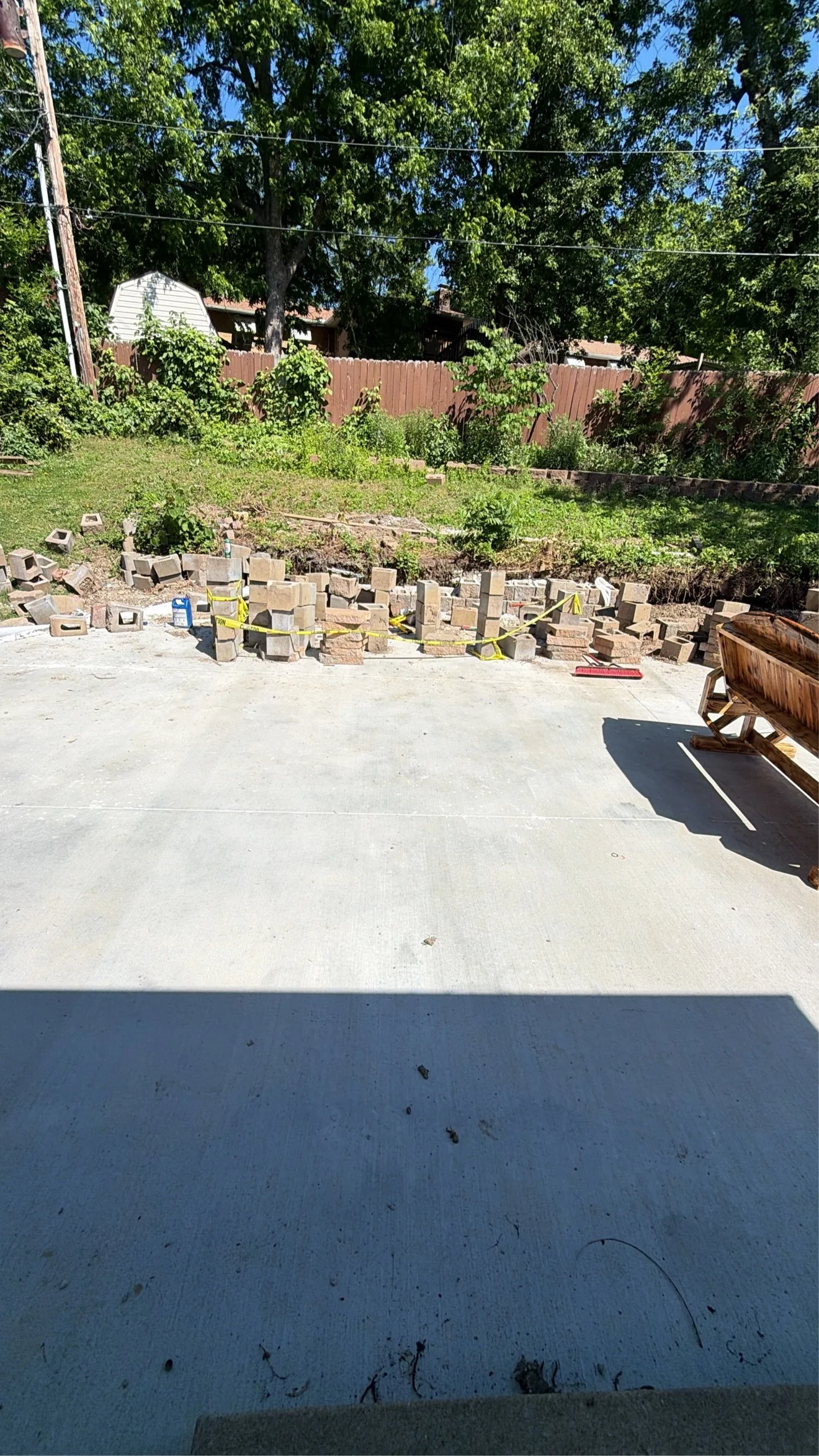 New patio poured — wall blocks staged