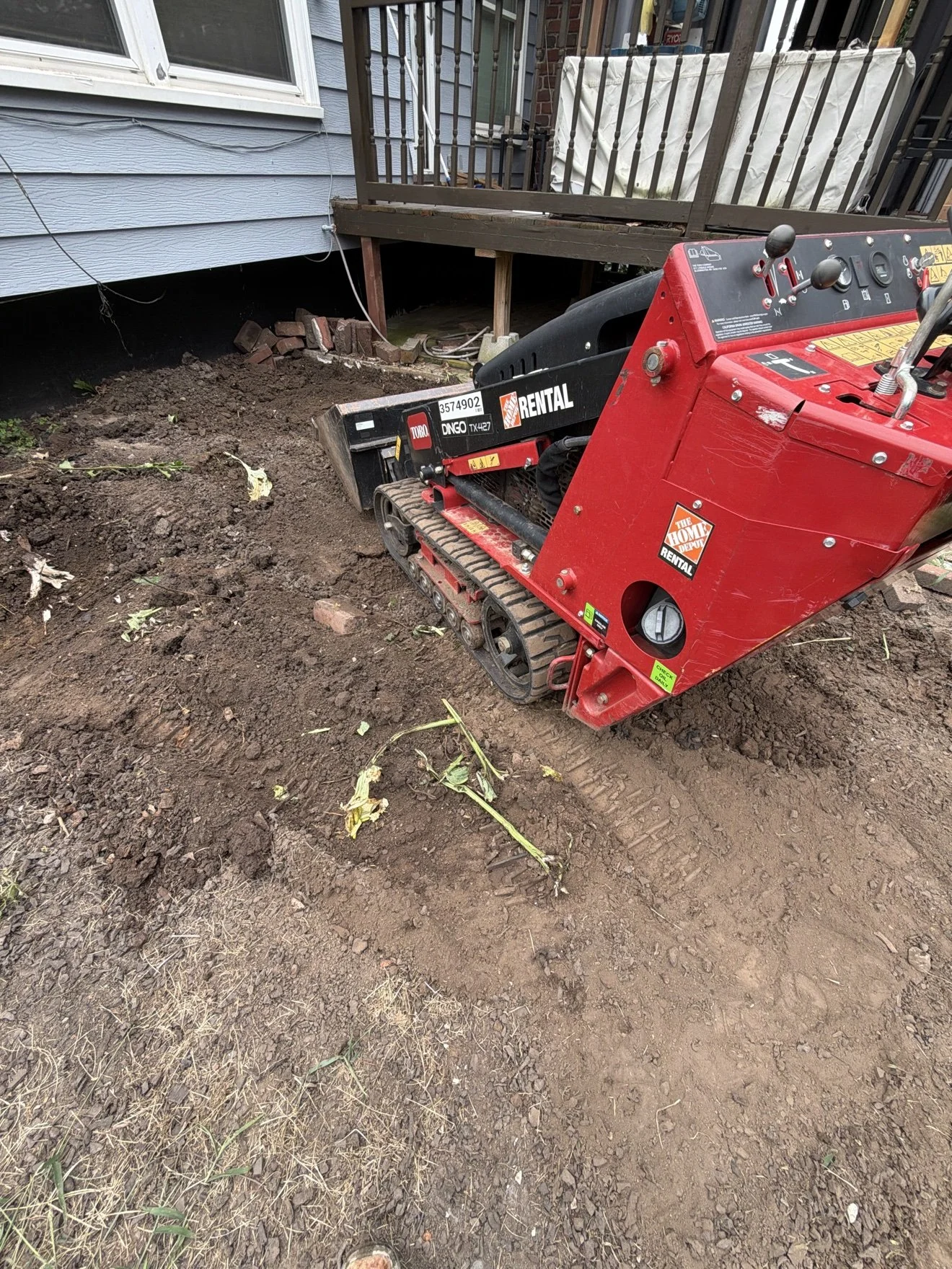 Grading the patio base with the Dingo mini loader