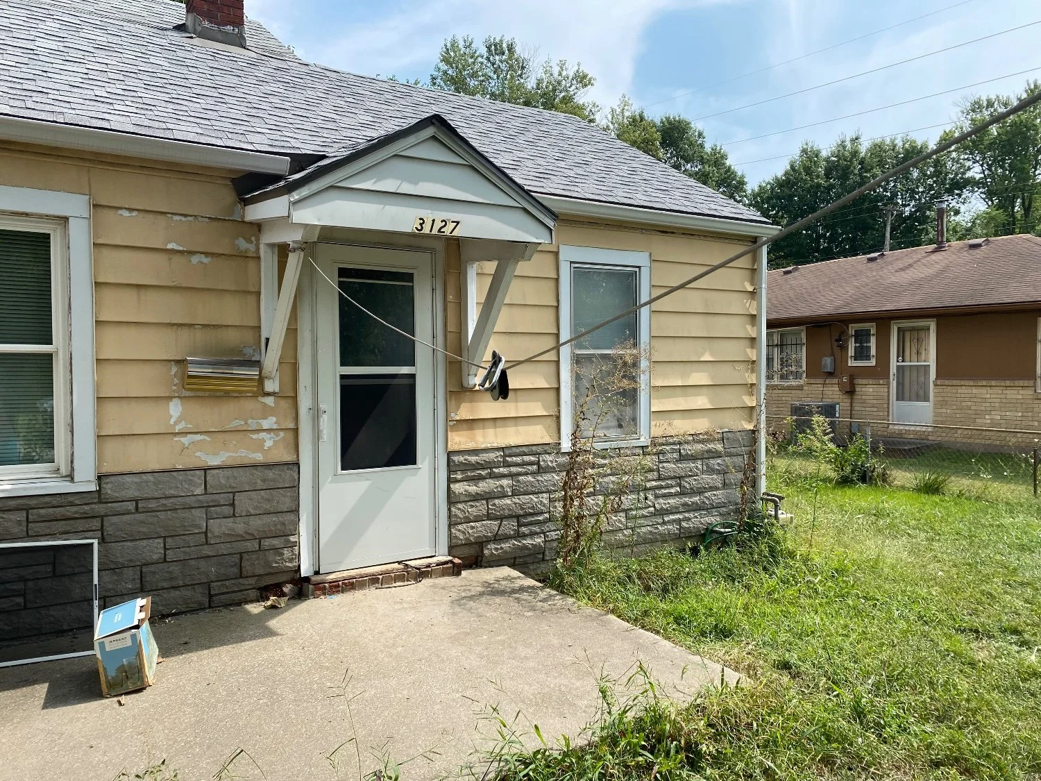Exterior — peeling paint, worn siding