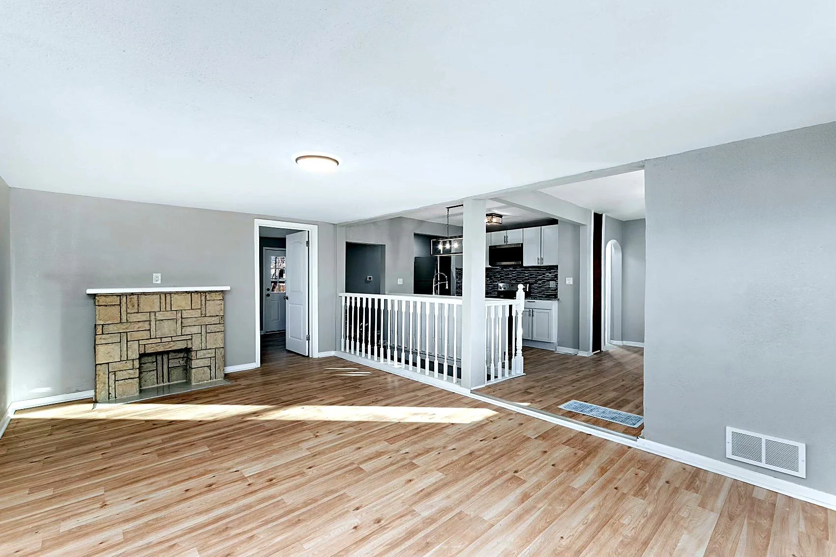 Living room — new flooring, paint, stone fireplace