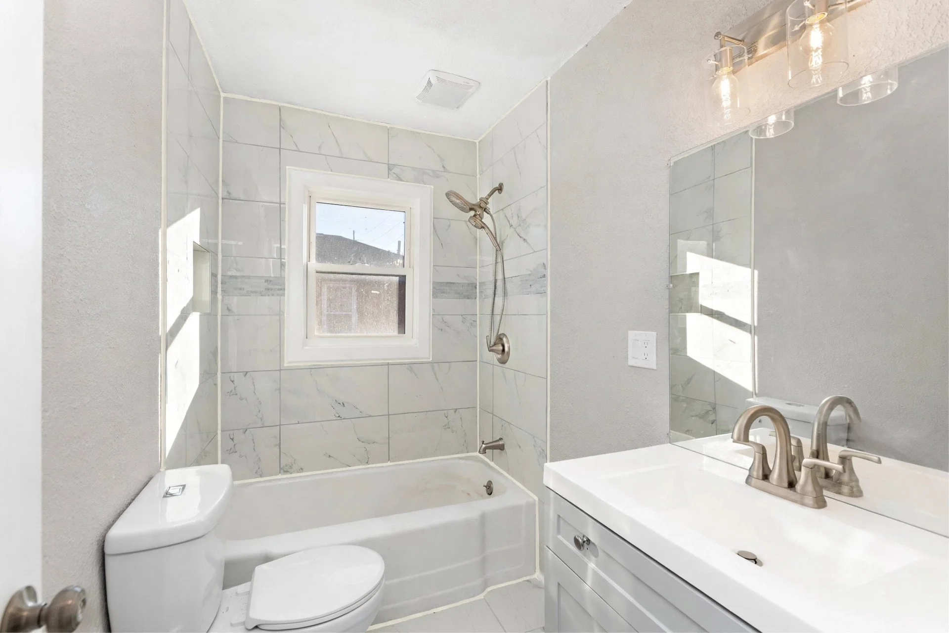 Bathroom — marble-look tile, tub and shower