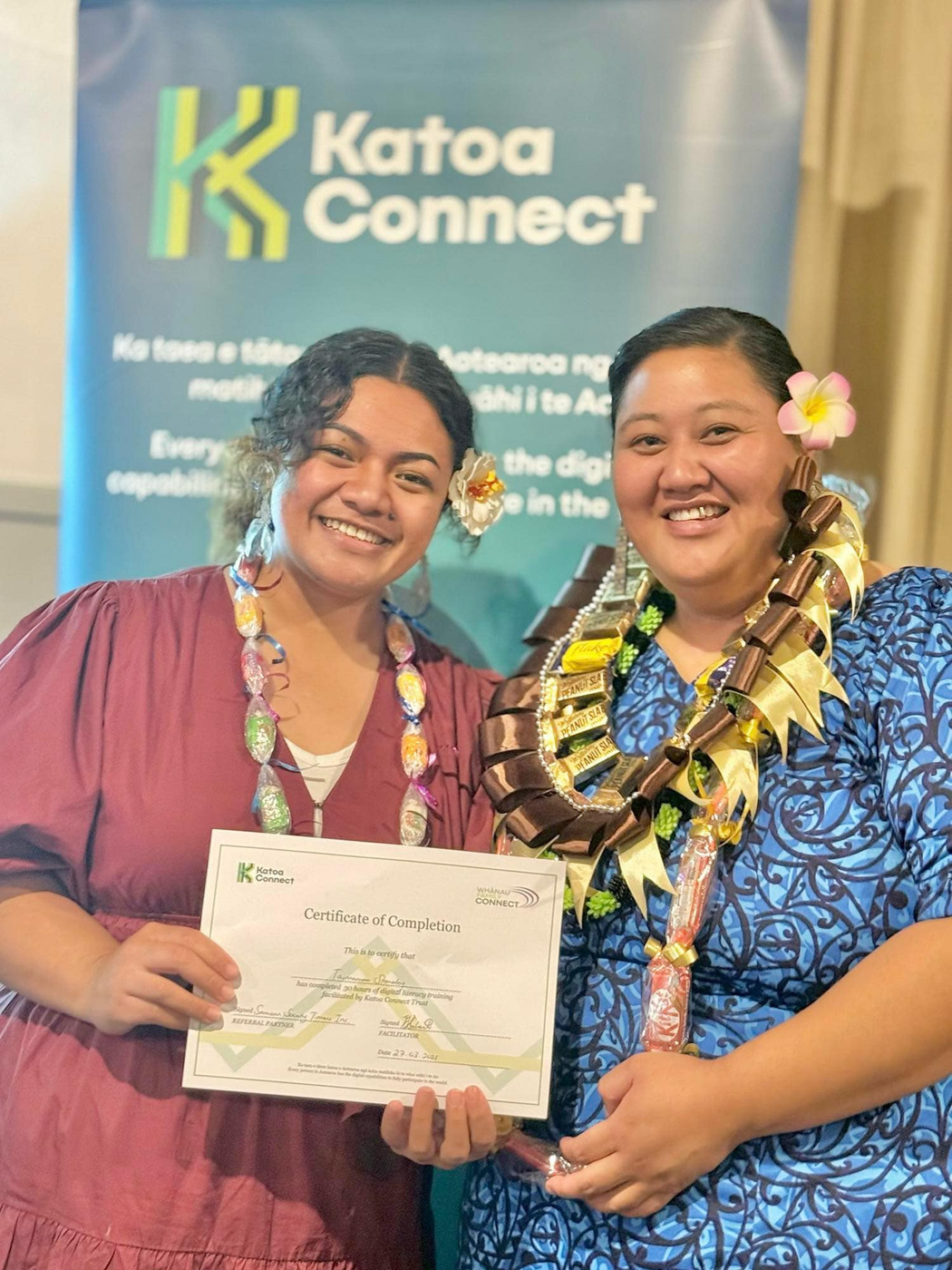 Katoa Connect programme facilitator and learner smiling while holding a certificate of completion at a community graduation event