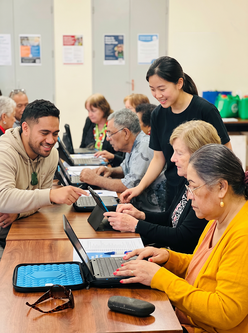 Katoa Connect learners developing digital skills on laptops during a community training session, building confidence, connection, and capability through hands-on technology support.