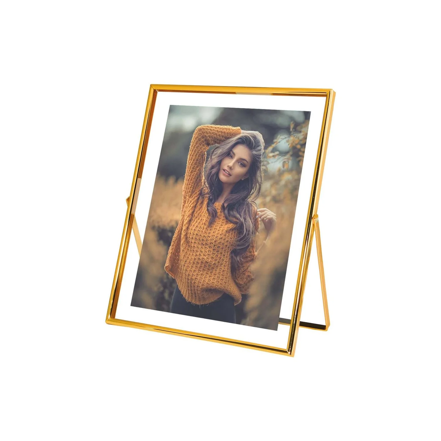 A portrait photograph of a woman displayed on a gold-framed tabletop mirror, set against a plain white background.