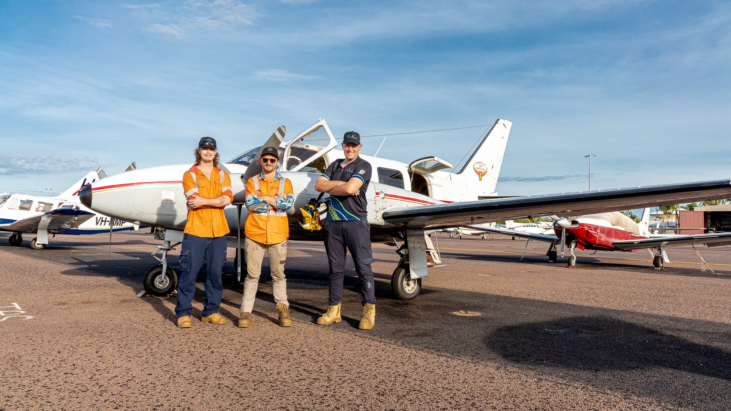 The TEC Automation team standing infront of fixed wing plane to do remote work.