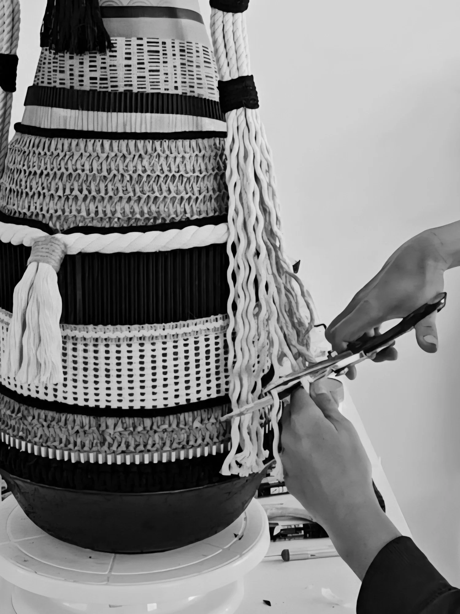 Close up of an artist working on a sculpture in her studio.