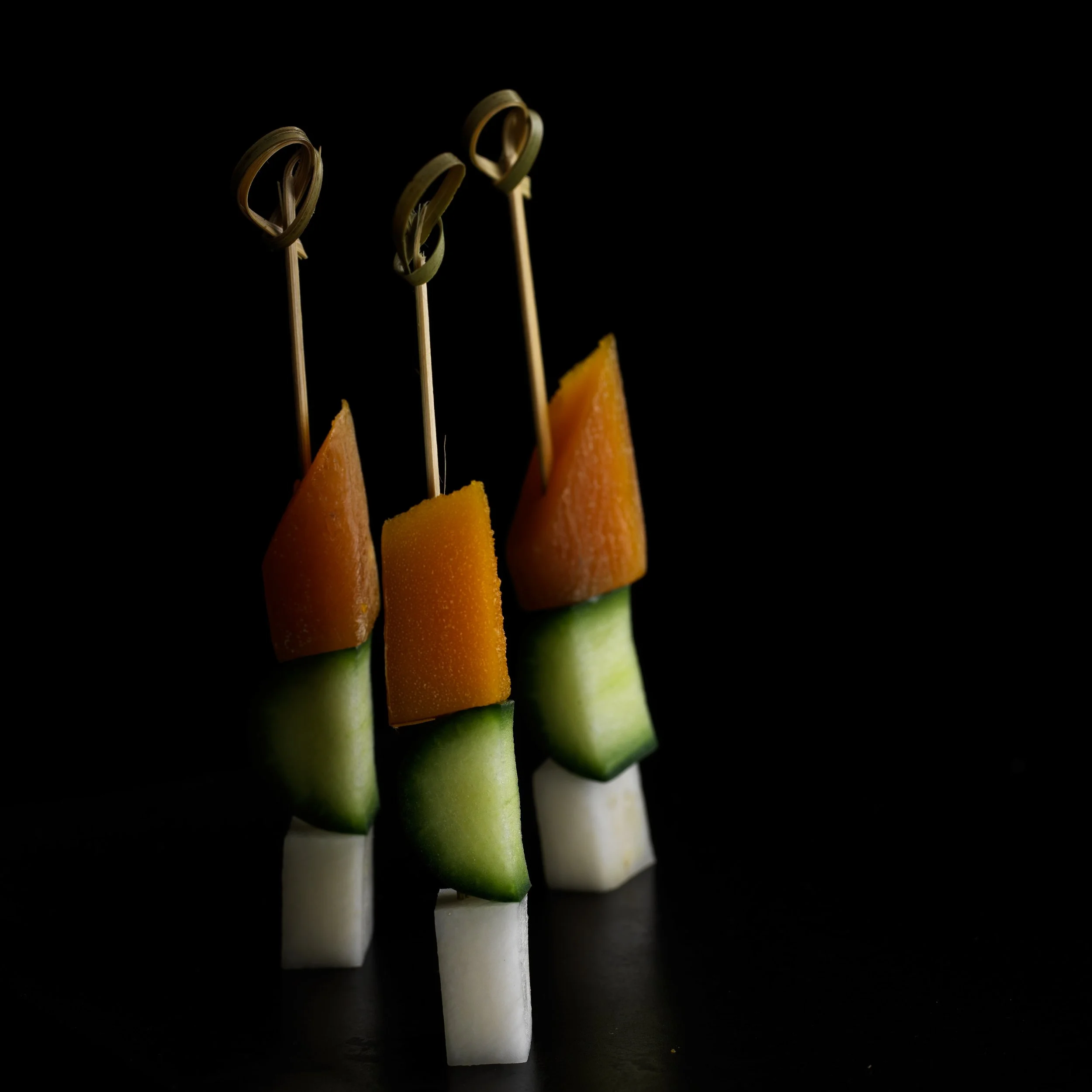 Luxury appetizer styling, bottarga and cucumber skewers, minimal commercial still life by Stavros Kostakis Photography