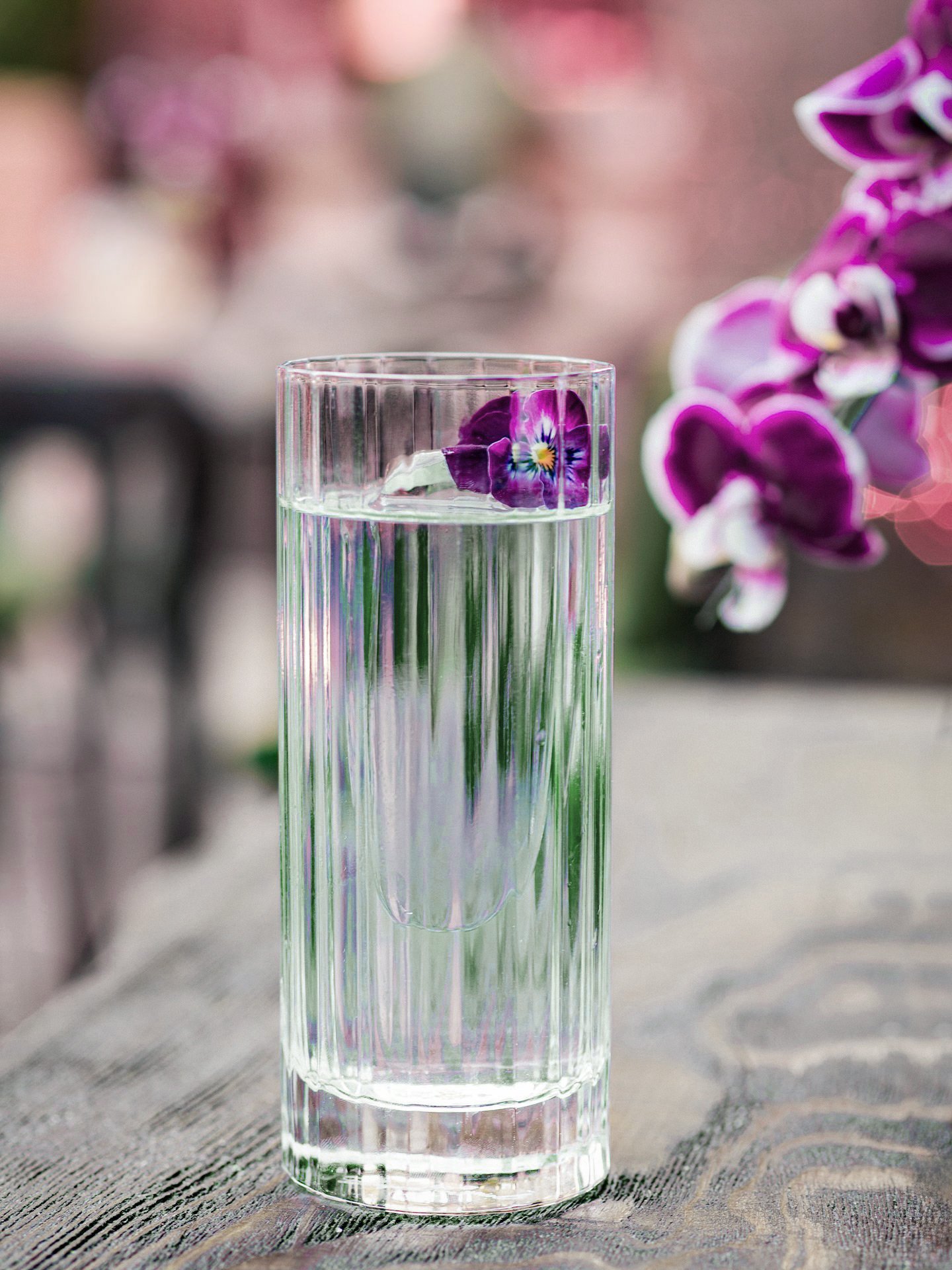 Signature botanical cocktail photographed by Stavros Kostakis, highlighting glass texture and floral elements at Hide and Seek Athens.