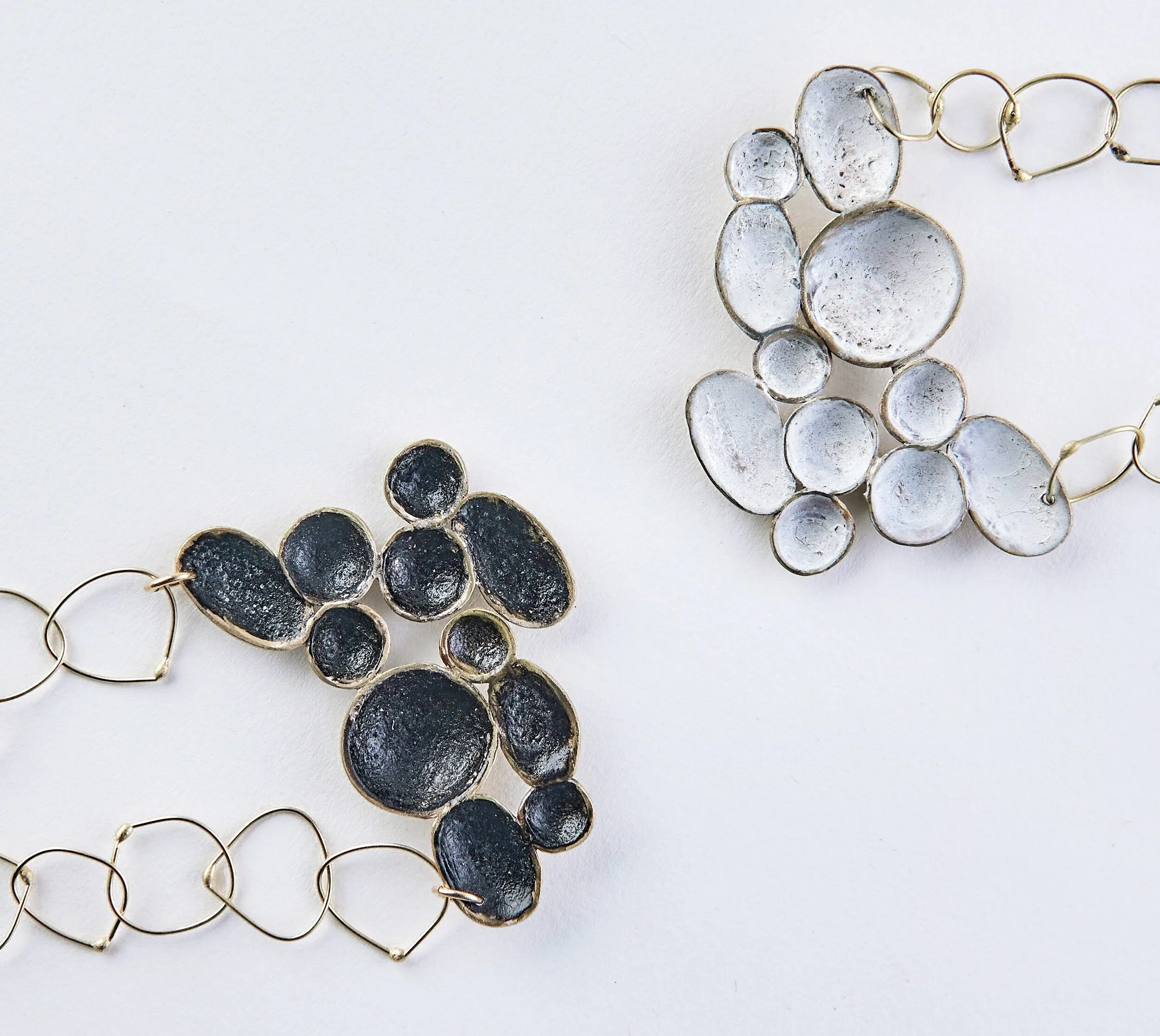  Dora Haralambaki | E-commerce product photography of contemporary jewelry by Dora Haralambaki. High-key studio shot on white background showcasing artisanal textures and silver details.