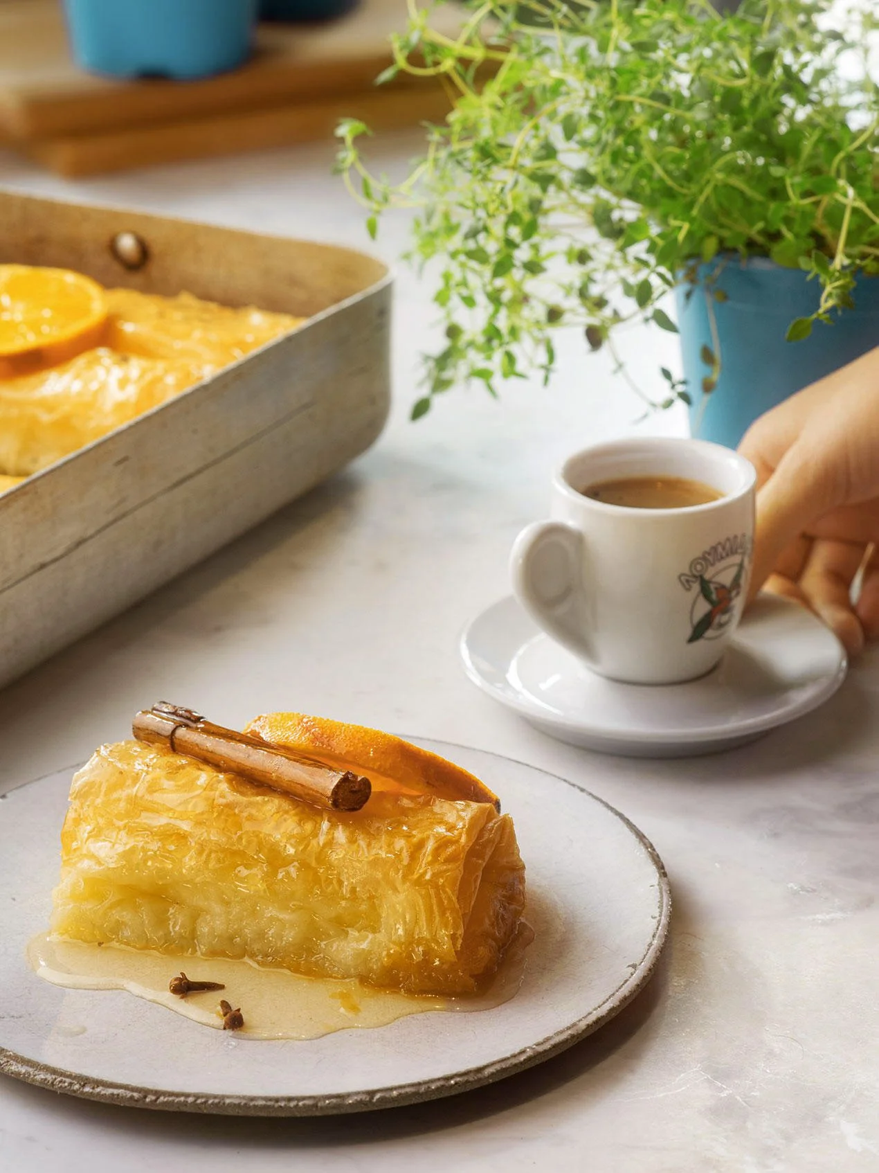 Traditional Greek Galaktoboureko dessert with syrup and cinnamon at Irodion restaurant, Capelle aan den IJssel, Netherlands. High-end food photography with lifestyle elements and coffee pairing. Shot by Stavros Kostakis.
