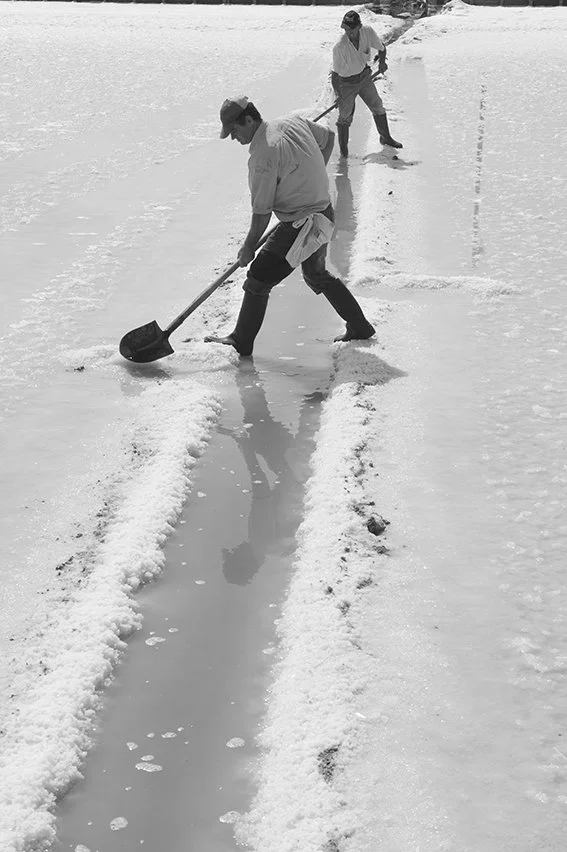 Traditional salt harvesting process, documentary photography of local industry by Stavros Kostakis Photography.