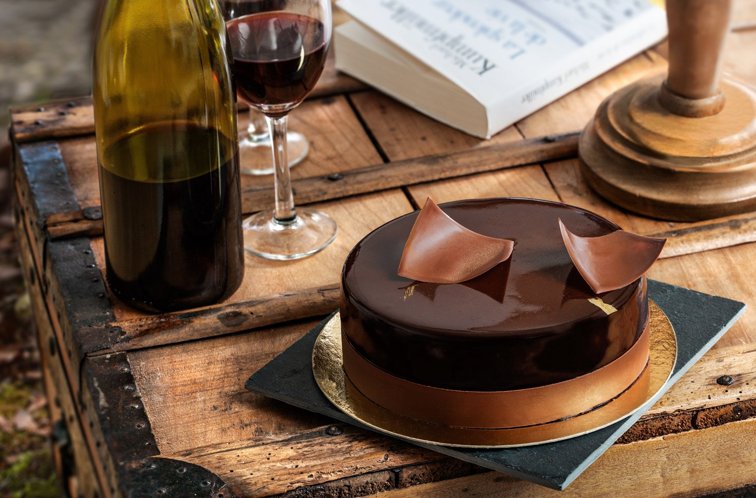 A symphony of chocolate and elegance. This editorial shot for Nikolas Koulepis Patisserie in Brussels showcases a premium chocolate entremet in a sophisticated setting. Stavros Kostakis uses natural, moody lighting and vintage elements to highlight t
