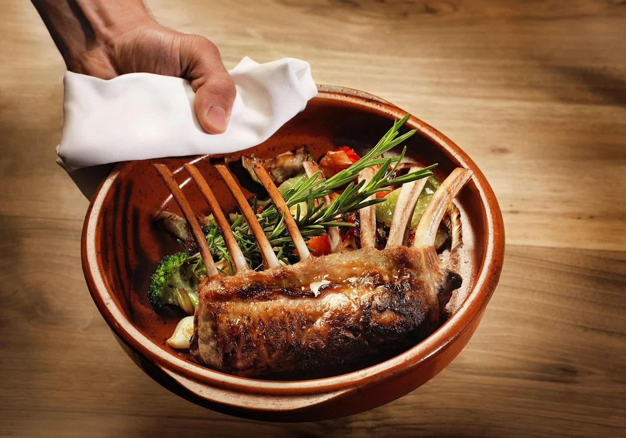 Capturing the rustic essence of Greek culinary tradition. This image highlights the beauty of simple, authentic ingredients served in traditional clay cookware. A documentary approach to the Greek tavern experience, focusing on texture, warmth, and t