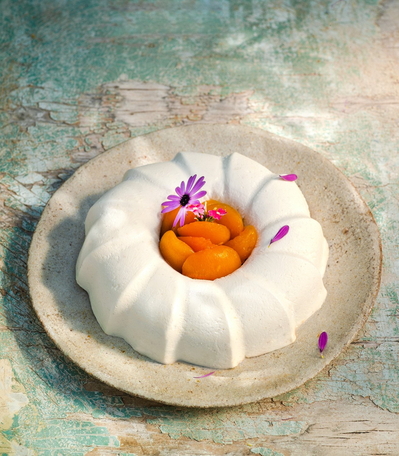 Fage Total. Professional food photography of a FAGE Total yogurt dessert with apricots and purple flowers on a rustic teal background, shot by Stavros Kostakis.