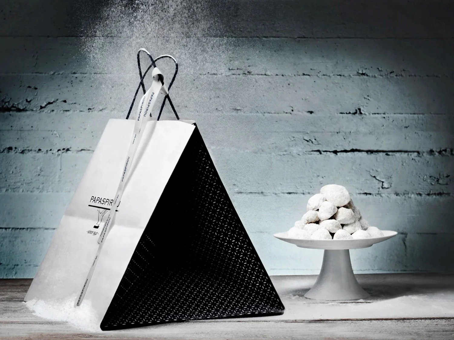 Advertising photography by Stavros Kostakis for Papaspirou, featuring the unique triangle Christmas packaging with powdered sugar snow.