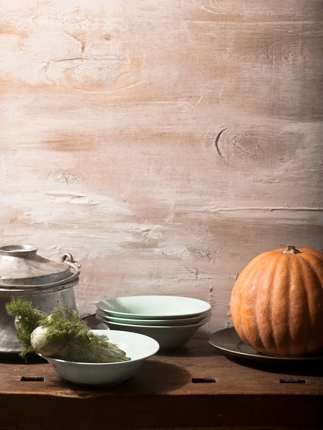 Editorial Still Life. Minimalist still life with a pumpkin and fennel on a rustic wooden table, designed for editorial magazine layouts by Stavros Kostakis.