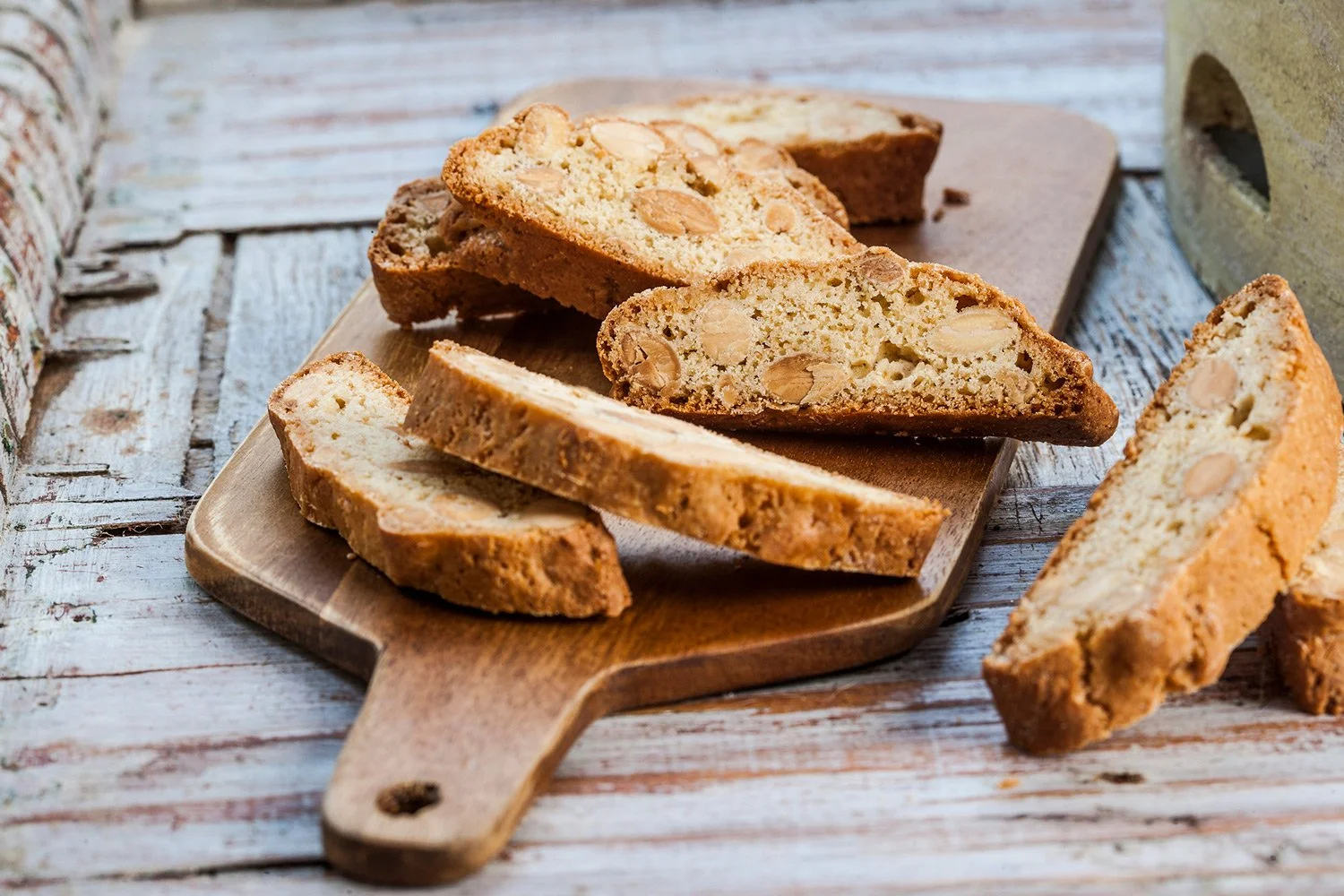 Commercial photography for Papaspirou Bakery featuring artisan almond biscotti on a wooden serving  board photography Stavros Kostakis