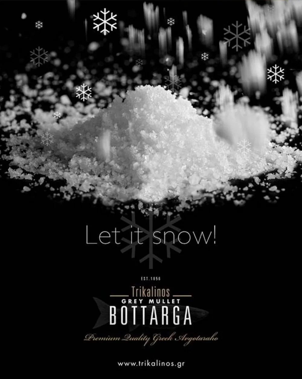 High-end commercial food photography for Trikalinos Fleur de Sel. "Let it snow" conceptual still life showing salt crystals on black background. Part of a culinary strategy and brand asset project.
